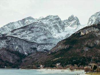 Scenic view of sea and mountains against sky