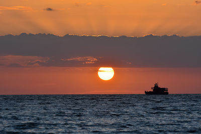 Scenic view of sea against orange sky