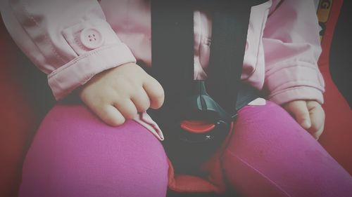 Midsection of child sitting on car seat