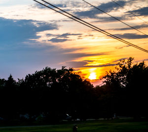 Silhouette trees against sky during sunset