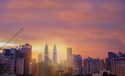 View of buildings against cloudy sky during sunset