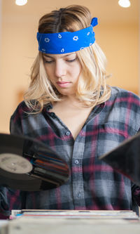 Close-up of young woman choosing vinyl records