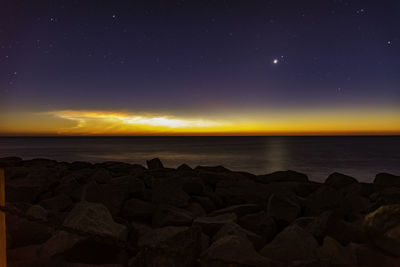 Scenic view of sea against sky at night