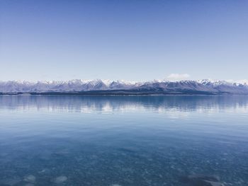 Scenic view of lake against clear blue sky