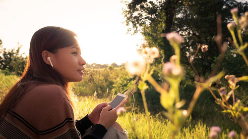 Portrait of young woman looking at plants