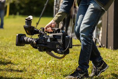 Low section of man photographing camera