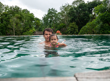 Portrait of man swimming in pool