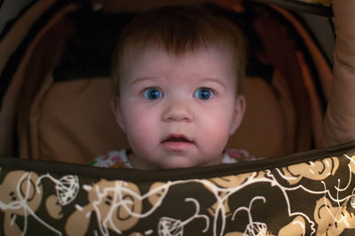 Portrait of cute baby girl in stroller