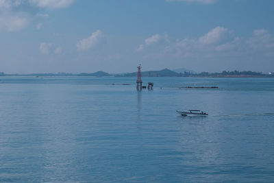 Sailboat in sea against sky