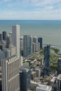 High angle view of buildings by sea against sky