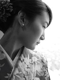 Close-up of young woman in kimono looking away
