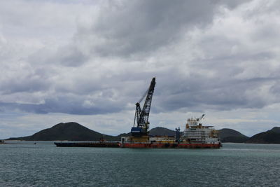 Commercial dock by sea against sky