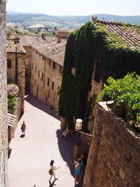 People by historic building against sky