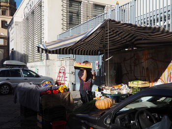 Man on street amidst buildings in city