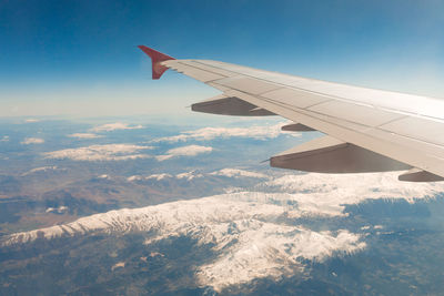 Aerial view of snowcapped mountain against sky