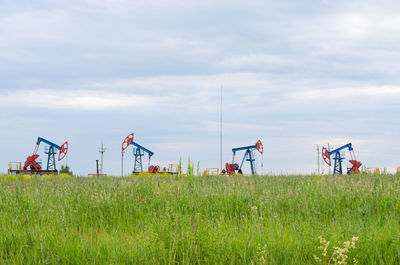 Oil production on the background of grass and sky.