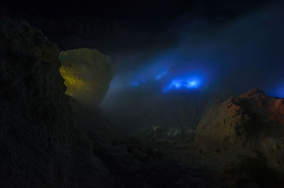 Scenic view of volcanic mountain against sky at night