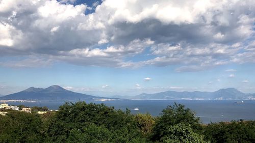 Scenic view of sea and mountains against sky