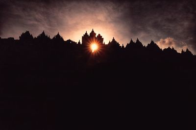 Silhouette landscape against sky during sunset