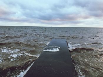 Scenic view of sea against cloudy sky