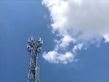 Low angle view of communications tower against sky