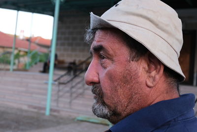 Portrait of man wearing hat looking away