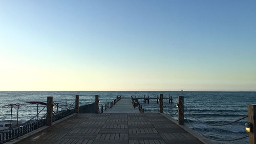 Pier over sea against clear sky