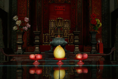 Illuminated chinese altar with reflection of it