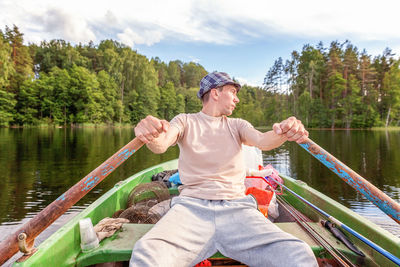 Full length of man in lake against trees