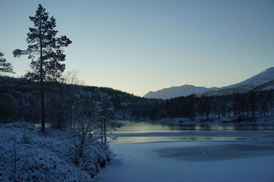 Scenic view of frozen lake against clear sky