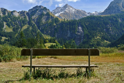 Scenic view of field and mountains against sky