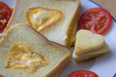 Close-up of heart shape bread with cheese in plate