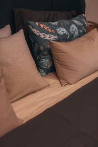 Beige and gray pillows and bedding. minimalistic style in the interior. vertical