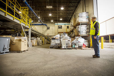 Profile view of manual worker standing in industry