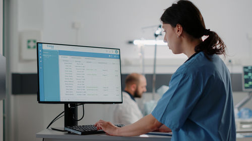 Nurse using computer at clinic