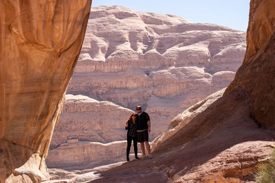 Rear view of man standing on rock formation