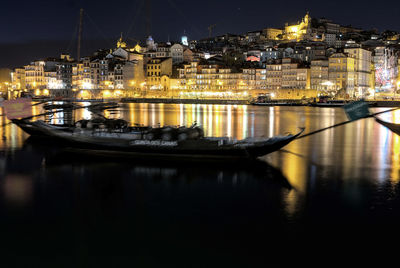 Illuminated buildings in river at night