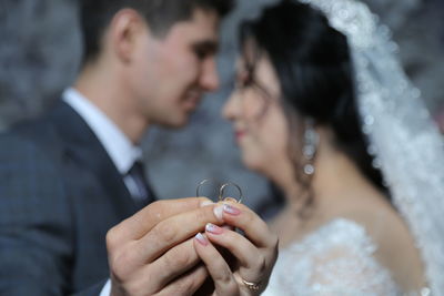 Midsection of couple holding hands