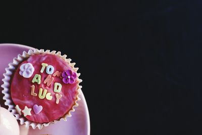 Close-up of cupcakes against black background