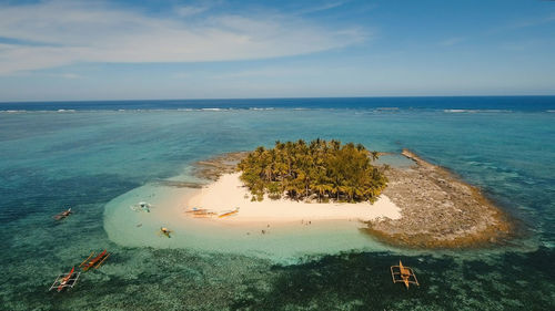 Aerial view of beautiful tropical island guyam with white sand beach. 