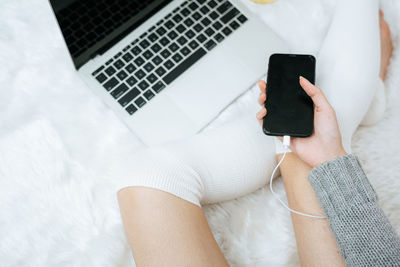 Midsection of woman using mobile phone