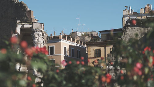 Low angle view of buildings in city against clear sky