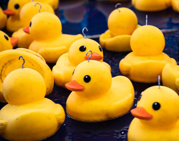 Close-up of yellow toys floating in water