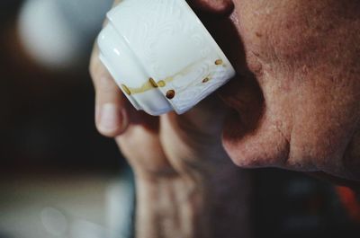 Cropped image of man drinking coffee