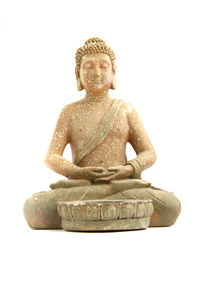 Close-up of buddha statue against white background
