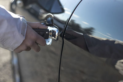 Cropped hand of man holding car