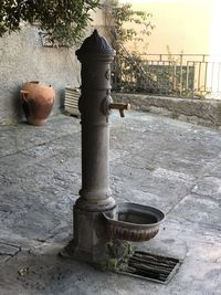 Close-up of water fountain against building