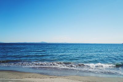 Scenic view of sea against clear blue sky