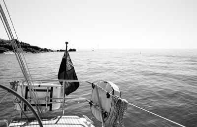 Ship sailing on sea against clear sky