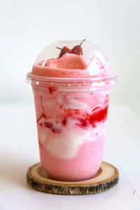 Close-up of apple with ice cream in glass on table